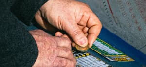 A man scratching a lottery ticket