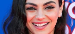 Mila Kunis smiles close up