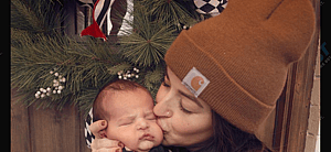 Tia Booth kisses her son