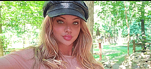 Dana Hamm poses in a pink top and black skirt