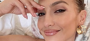 Jennifer Lopez poses from her bed