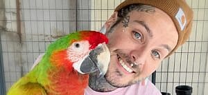Tyler Nolan and a parrot