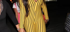 Rapper Megan Thee Stallion wears a striped yellow jumpsuit as she parties at the Delilah restaurant