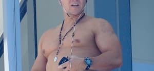 Mark Wahlberg shows off his muscles while waving shirtless from his South Beach hotel balcony