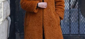 Selena Gomez is all smiles sporting a long brown orange furry coat while filming Only Murders In The Building in NYC
