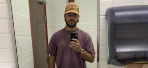 A photo showing Noah Erb taking a mirror selfie in the bathroom