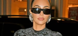 Kim Kardashian shows off her famous curves in a black dress
