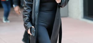 Kim Kardashian wears a long black leather jacket as she is seen leaving a basketball game in Thousand Oaks Ca