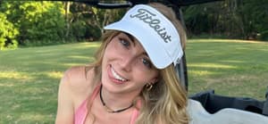 Grace Charis poses in a pink crop top