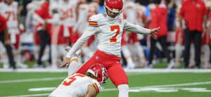 Harrison Butker kicking the football
