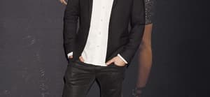 Tom Schwartz posing in a black jacket and white shirt