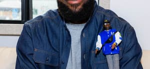 LeBron James posing with his Ken Barbie doll.