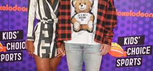 Tavis Kelce and Kayla Nicole posing together on the red carpet.