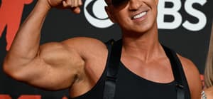 Mike "The Situation" Sorrentino posing with his biceps on the red carpet.