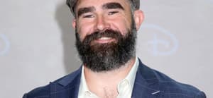 NFL star Jason Kelce posing on the red carpet.