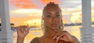 Mickey Lee posing in front of a sunset