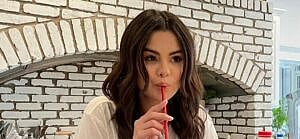 Selena Gomez drinking a milk shake