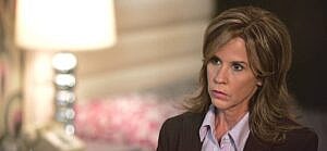 A photo showing Linda Blair in a brown suit and purple inner T-shirt.