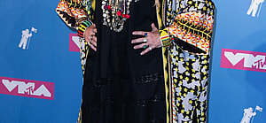 A photo showing Madonna at an event in a traditional outfit.
