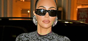 Kim Kardashian shows off her famous curves in a black dress