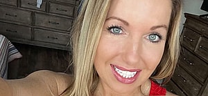 Courtney Ann in a red tank top and jeans