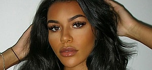 Izzy Fairthorne poses in a black bra