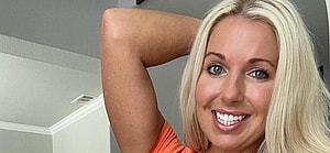 Courtney Ann poses in an orange bikini