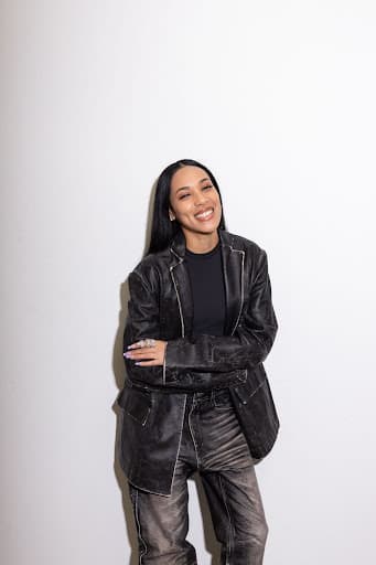 Aleali May posing in her jacket