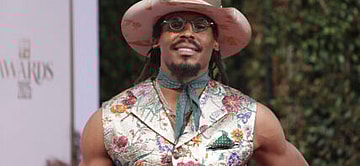 Cam Newton posing on the red carpet.