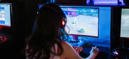 Woman playing video game on computer