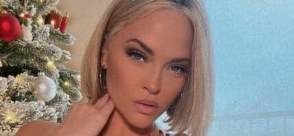 Alexis Texas in front of a christmas tree
