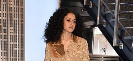 Chase Infiniti wearing a golden outfit