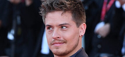 Dylan Sprouse posing on the red carpet.