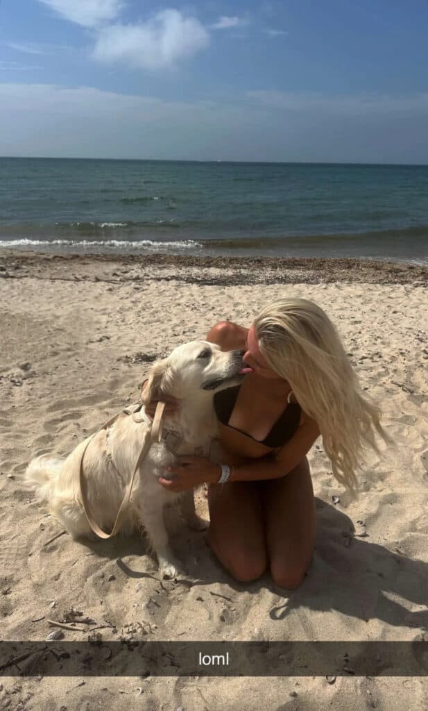 Olivia Dunne poses with her dog.