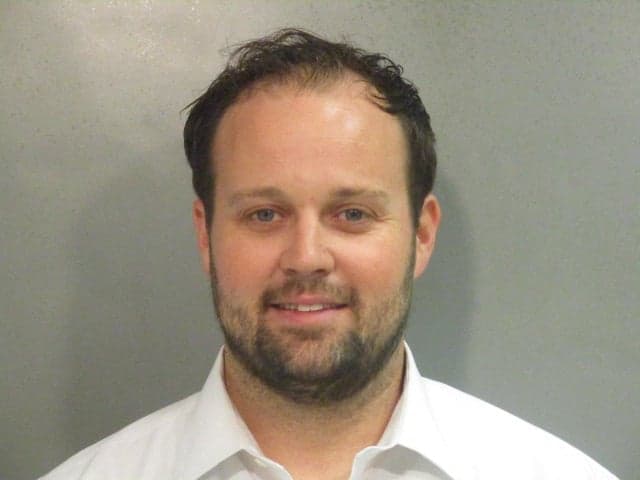 Josh Duggar smiles in new mugshot photograph after being found guilty in child pornography case