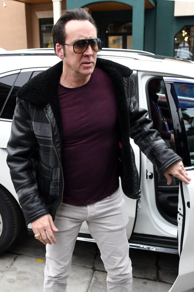 Nic Cage looks stylish in sunglasses and white pants as he promotes 'Mandy' at Sundance