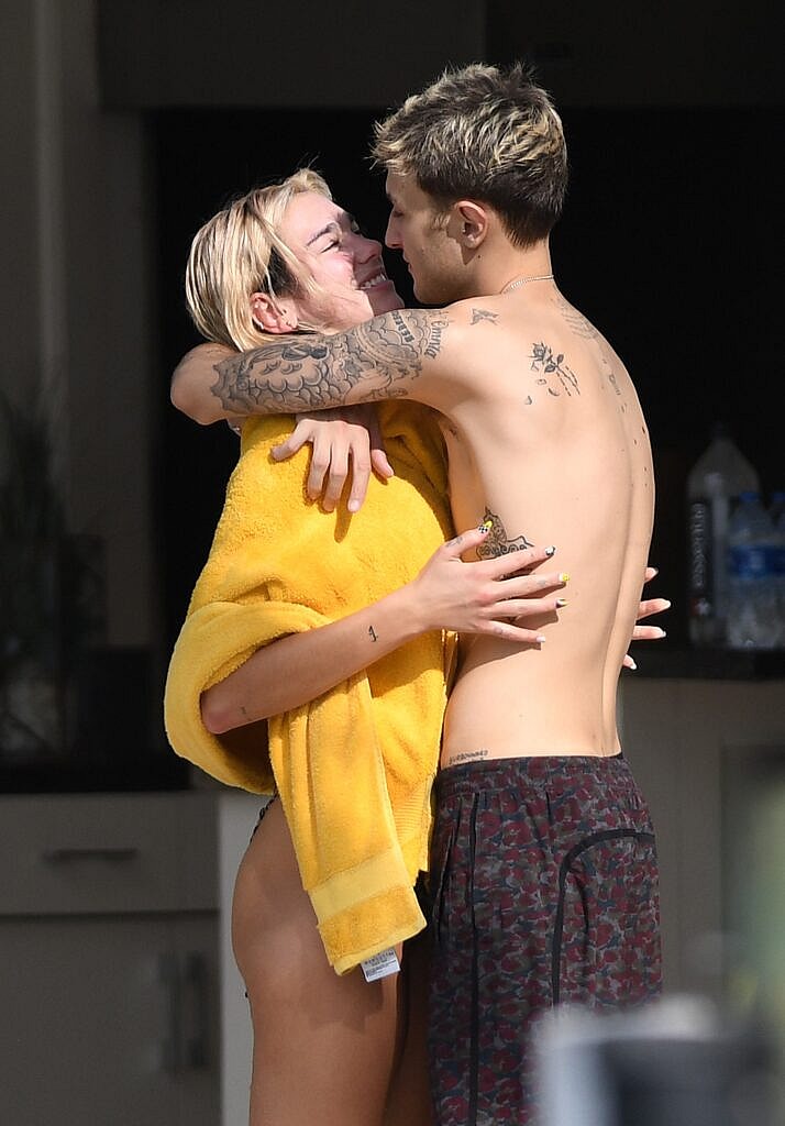 Singer Dua Lipa wears a tiny leopard print bikini as and shows plenty of PDA with boyfriend Anwar Hadid as they relax by the pool in Miami