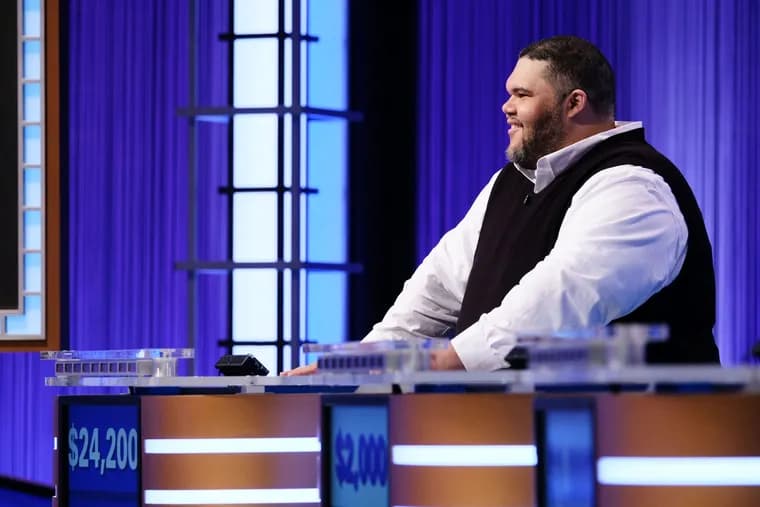 Ryan Long at the Jeopardy! contestant podium with his winnings displayed