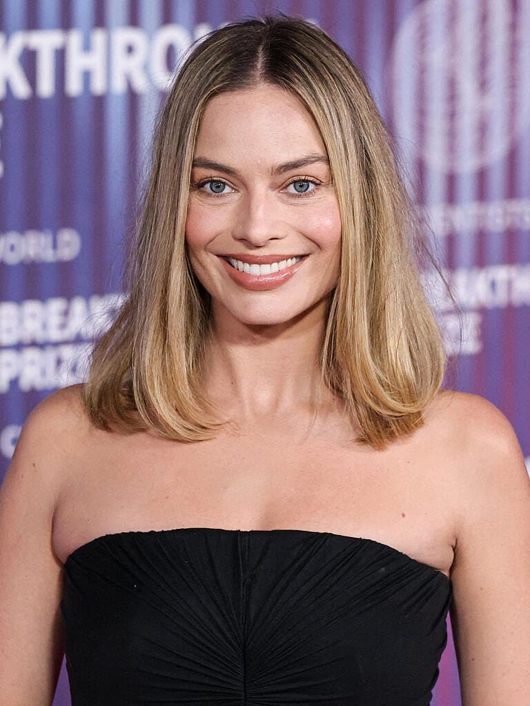 Margot Robbie smiling for an event