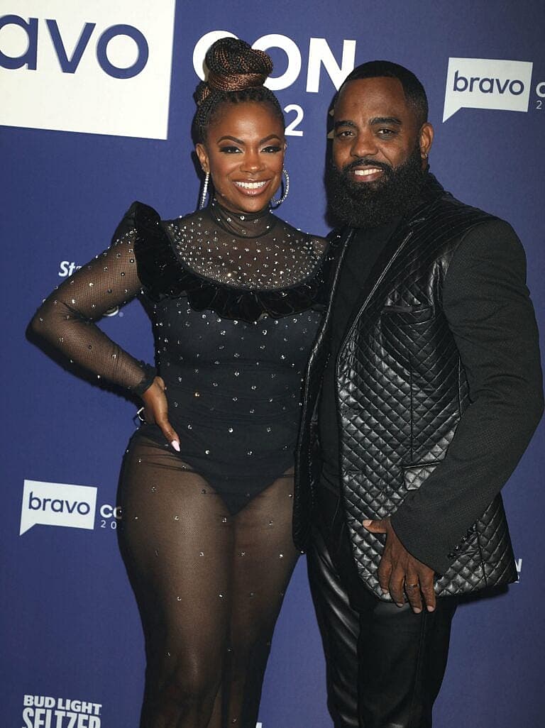 Kandi Burruss and a man pose together at a Bravo event