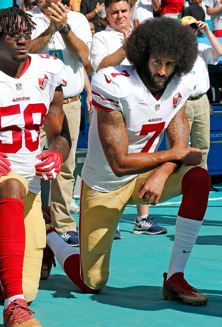 quarterback Colin Kaepernick (7) take a knee during the national anthem before a game against the Miami Dolphins on Sunday, Nov. 27, 2016