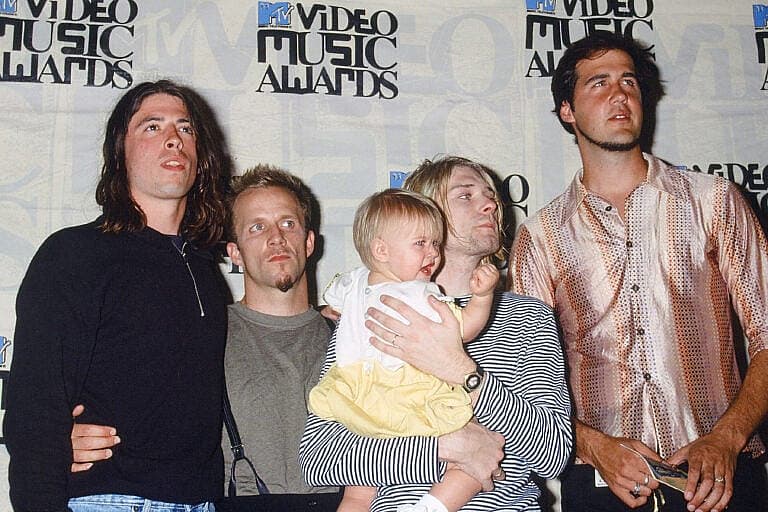 Courtney Love and Kurt Cobain with band members and child at MTV Video Music Awards event