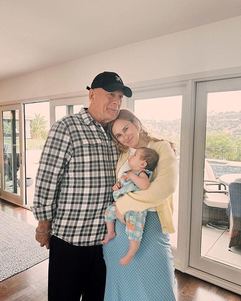 Bruce Willis with his wife and young child in a home setting