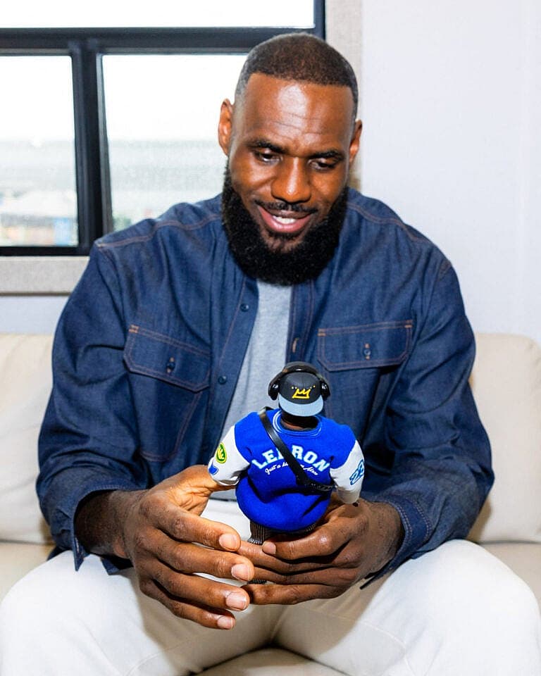 LeBron James posing with Ken doll.