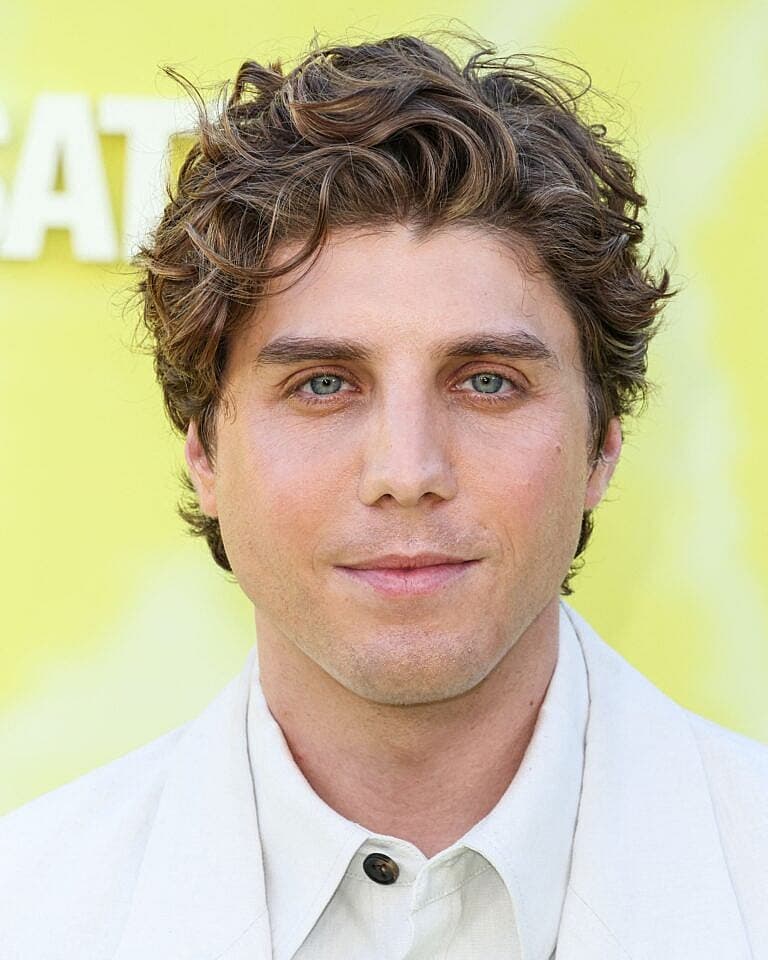 Lukas Gage posing on the red carpet.