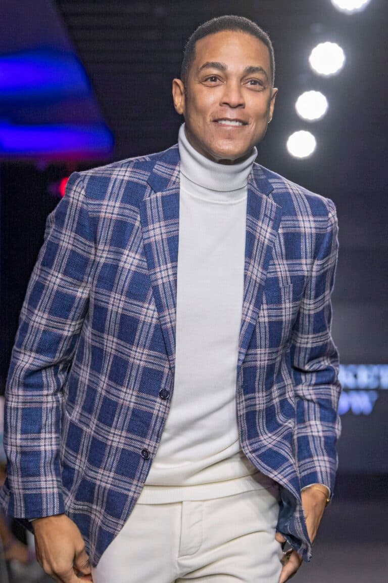 Don Lemon in a blue suit jacket smiling.