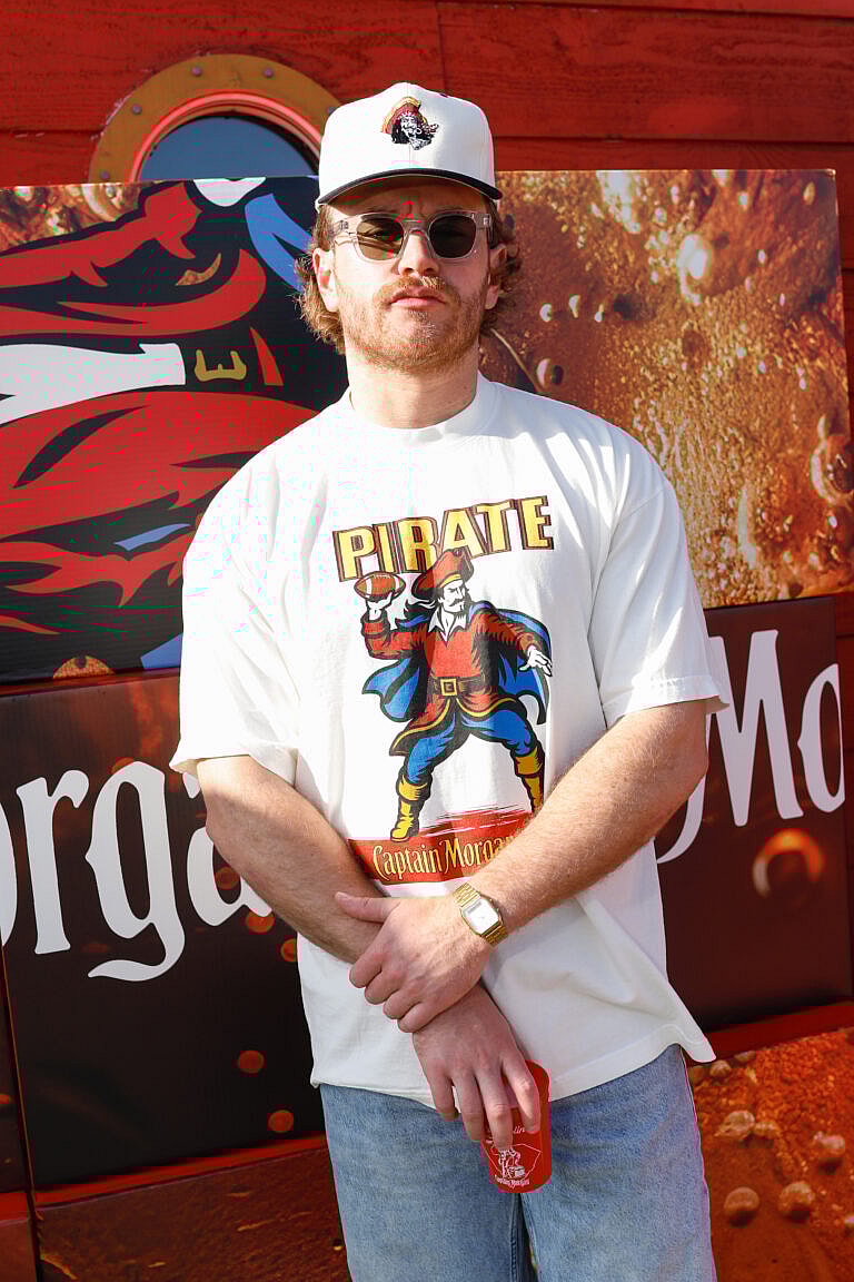 Summer House star West Wilson is teaming up with Captain Morgan to bring The Captain’s Challenge to tailgates across the country and gave fans a first look at the brand’s upcoming collab with Pirate Worldwide.