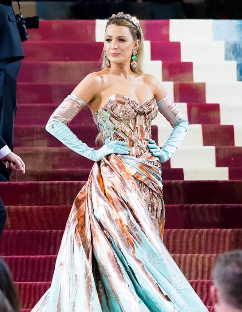 Blake Lively poses on red carpet steps in beaded gown and long gloves