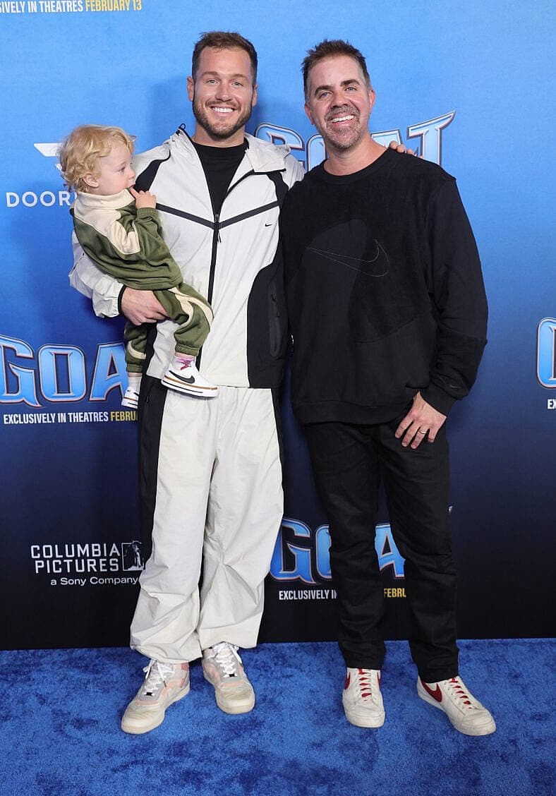 Colton Underwood posing on the red carpet with his family.