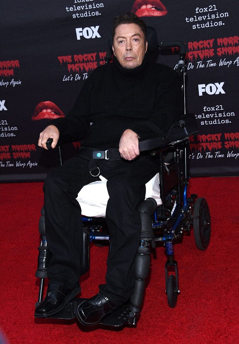 Tim Curry in a wheelchair